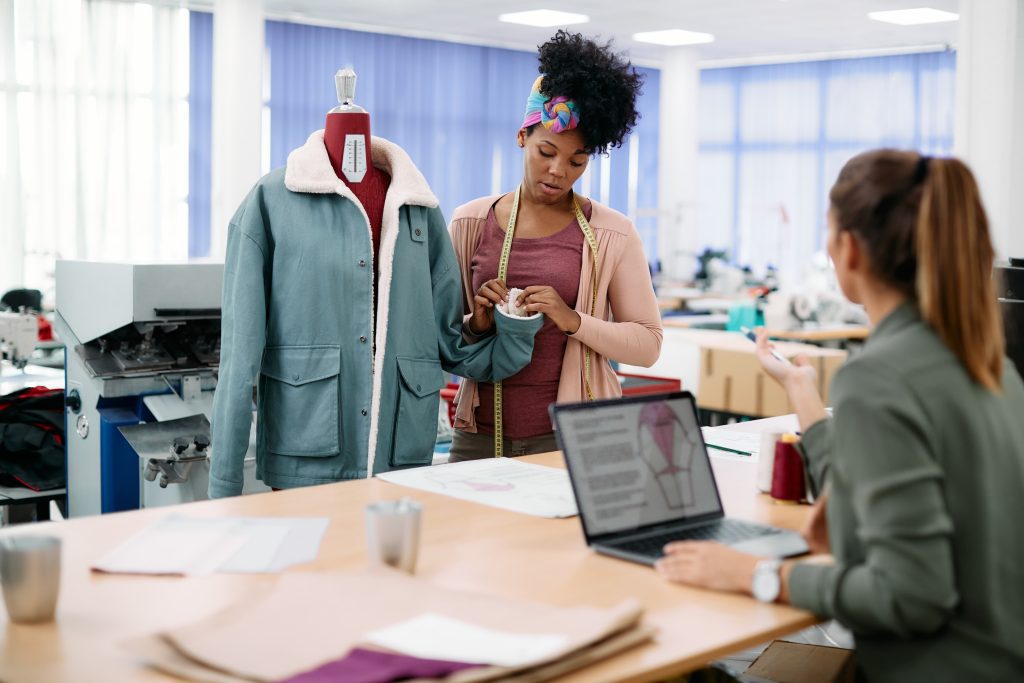 Women using Clothing Design Software to finish a jacket