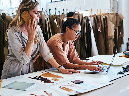 Women creating fashion data for company