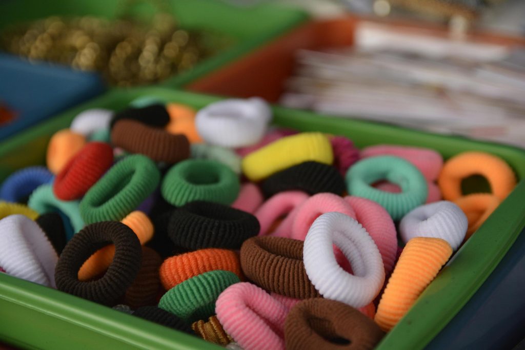 Colorful fabric hair ties in high-volume production managed with an ERP for accessories to handle SKU variation, material tracking, and inventory across product categories.