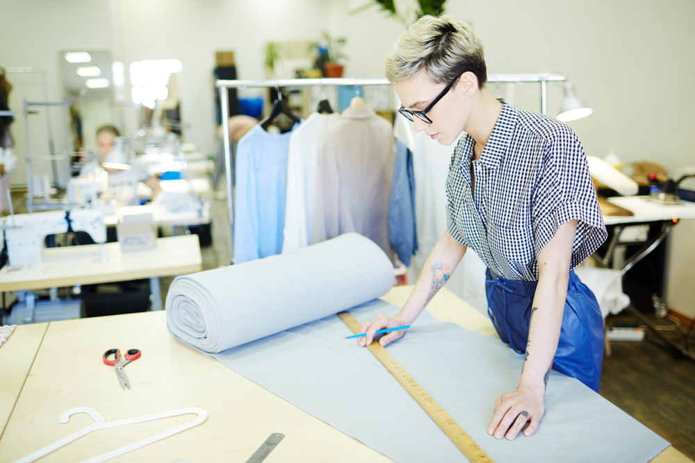 Clothing manufacturing environment with fabric cutting and production equipment enhanced by garment costing software for better production and cost management.
