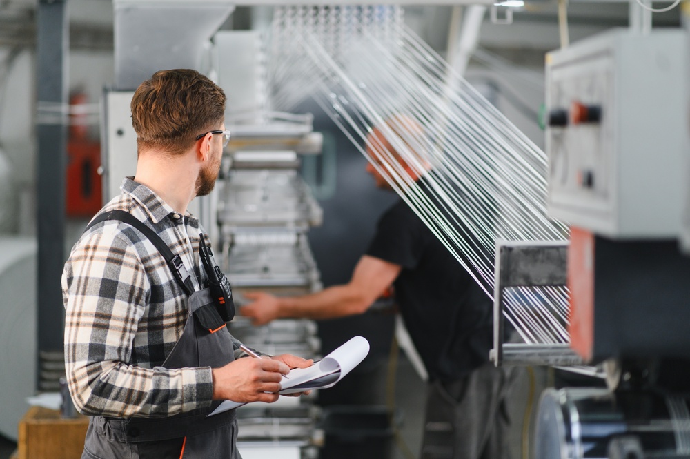 High-tech textile production machines handling fabric assembly and tracking operations via product lifecycle management software fashion.