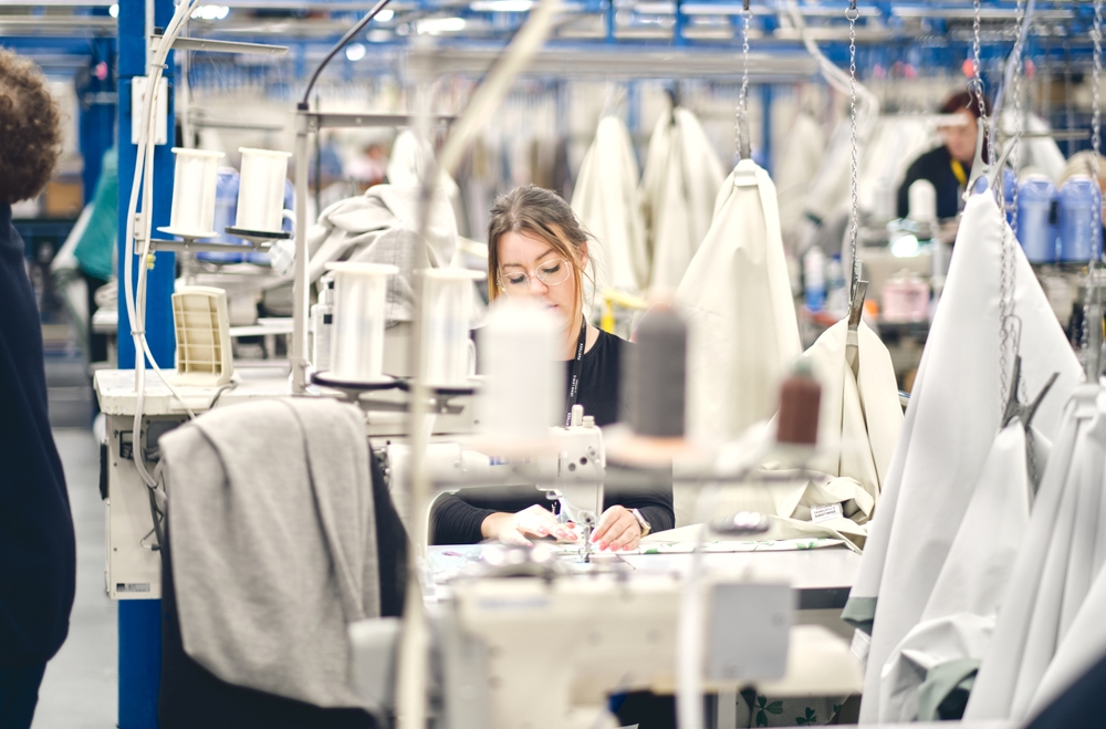 Modern garment production line with automated textile machinery supported by shop-floor-control-software-apparel-manufacturing-garment-industry for efficient factory operations.
