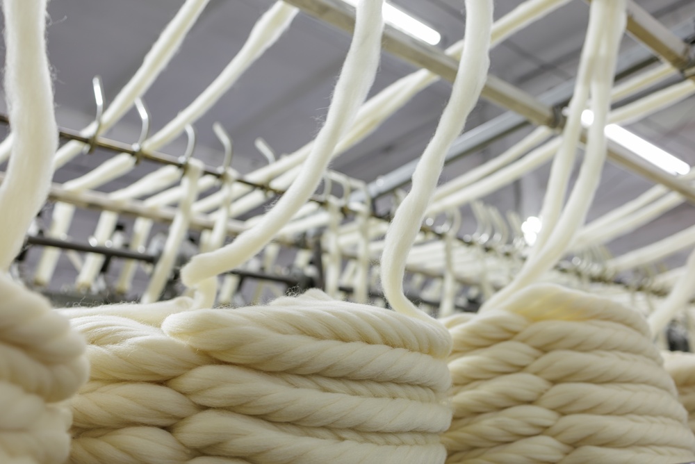 Apparel manufacturing equipment processing fabrics in a textile factory using shop-floor-control-software-apparel-manufacturing-garment-industry to streamline production workflows.
