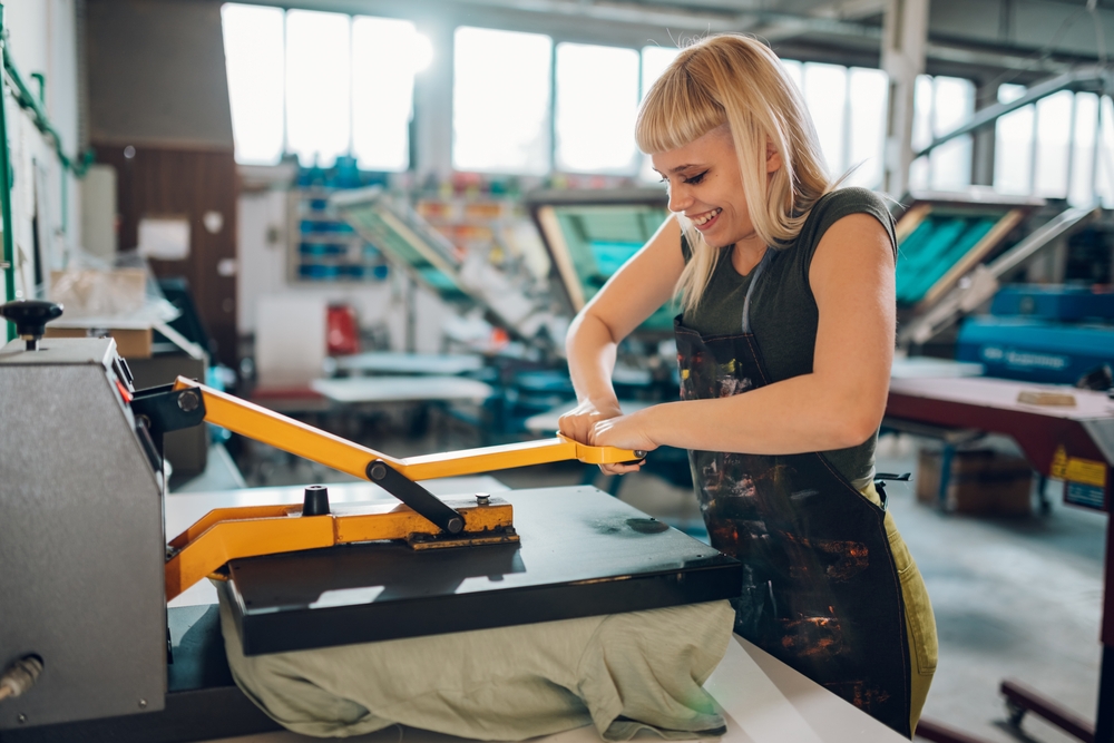 Modern clothing factory with fabric cutting and sewing operations supported by software for garment costing and margin analysis for accurate manufacturing costs.