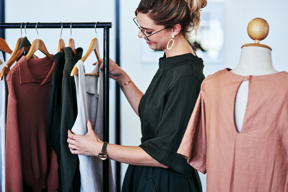 Retail clothing displayed in a fashion store, supported by software for garment costing and margin analysis that helps manufacturers price products accurately.
