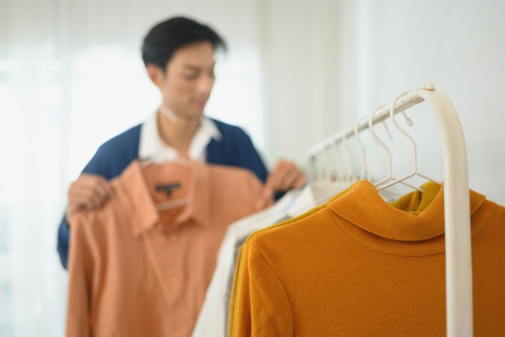 Clothing manufacturing team inspecting apparel quality with apparel supply chain management software supporting end to end supply chain visibility.
