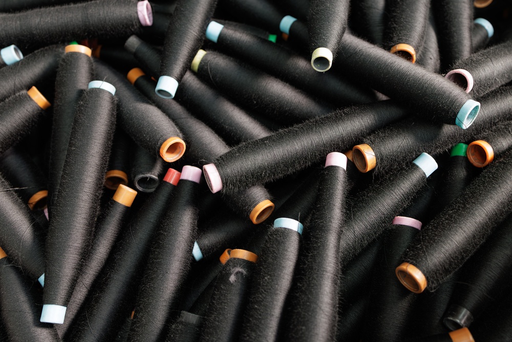 Rolls of thread that are accounted for in apparel production tracking data on the shop floor