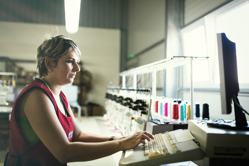 Pattern maker preparing a marker in PolyNest while a cloud vs on premise ERP setup keeps files close to the cutters.