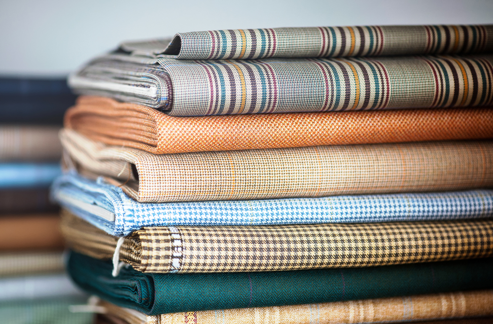 Stacks of fabric stacked in a textile warehouse tracked by clothing manufacturing software
