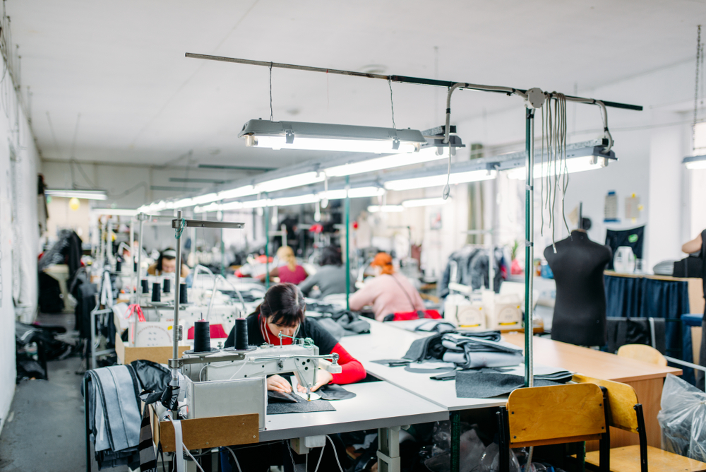 Industrial sewing machines in a garment factory supported by clothing manufacturing software