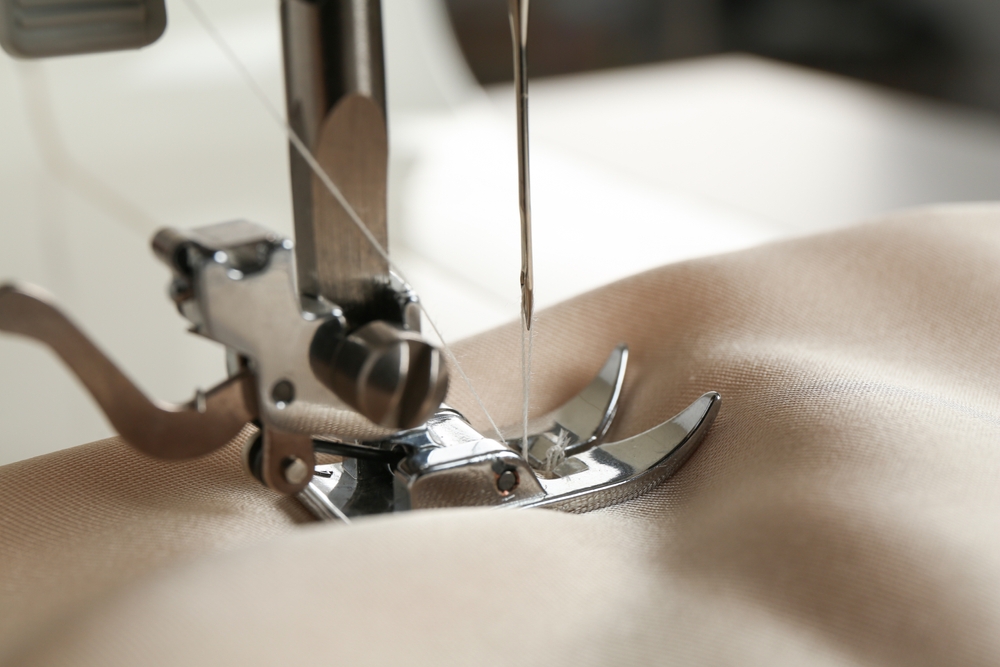 Sewing station using production management software to plan fabric lays and cut tickets